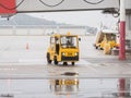 Russia, Sochi 02.11.2021. Yellow forklift truck rides on the airfield on a cloudy rainy day