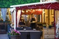 Russia, St. Petersburg - August 20, 2023: A waiter delivers food in a summer cafe in the evening