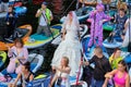 RUSSIA, ST.PETERSBURG - August 8, 2020: Woman dressed as a bride at the sup surfing festival Royalty Free Stock Photo