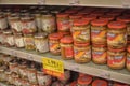 Banks with pickles and canned goods on the supermarket shelf during the coronavirus period