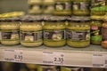 Banks with pickles and canned goods on the supermarket shelf during the coronavirus period