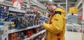 The buyer chooses children`s toys, car models in the supermarket