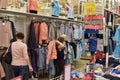 Buyers measure clothes in the supermarket