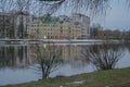 Russia, St. Petersburg, early winter, river embankment. A quiet, thoughtful urban landscape, a gray building is reflected in the q