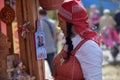 An elderly woman in Slavic national clothes at the festival of S