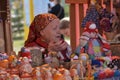An elderly woman in Slavic national clothes at the festival of S