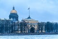 Russia, St. Petersburg, January 2021. The eastern gate of the Admiralty and the dome of St. Isaac`s Cathedral in winter.