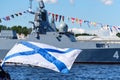 RUSSIA, ST.PETERSBURG - JULY 27, 2020: Andrew flag against the background of a warship at the parade