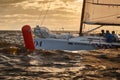 Russia, St. Petersburg, 23 July 2021: Competition of sailboats on the horizon in sea at sunset, the amazing storm sky of