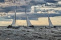 Russia, St.Petersburg, 23 July 2021: Competition of Three sailboats on the horizon in sea at sunset, the amazing storm Royalty Free Stock Photo