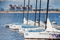 Russia, St.Petersburg, 07 July 2023: Six sheathed sailboats stand in port waiting for race, bowsprits and masts at sunny Royalty Free Stock Photo