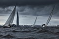 Russia, St.Petersburg, 17 June 2022: Teamwork in sailing regatta at stormy weather, skyscraper Lakhta center of gas