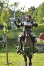 Knight on horseback in military armor at the knightly tournament on the reconstruction