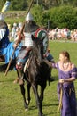 Knight on horseback in military armor at the knightly tournament on the reconstruction
