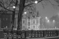 Russia, St. Petersburg, The Mansion of the architect Schroeter. Winter night view, snowfall, wind, night city lights. Black and w