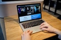 RUSSIA, ST.PETERSBURG - March 5: A girl browses an apple site on a laptop. Looking for apple tv