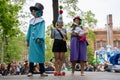 Russia, St. Petersburg, May 25, 2019: Event with dogs called Dachshund Parade. Costume procession, three people and pretty dog in