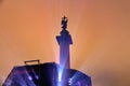 The monument to the angel of the city rises above the working light machine