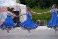 People in blue Russian national costumes dance at the International Festival Ã¢â¬ÅHave Contact