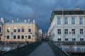 Russia, St. Petersburg, the Post Office Bridge over the Moika River, an expressive stormy blue sky and relief architecture. Great