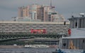 Russia, St. Petersburg, summer, Troitsky Bridge, tourist boats close-up, red tourist bus, modern building in the background, textu