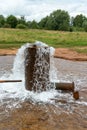 Russia, Staraya Russa, August 2021. Mineral spring flowing from a metal pipe. Royalty Free Stock Photo