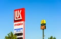 Street signboards of the Lukoil gas-station and McDonalds McAuto, 24 hours automobile services