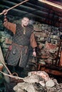 A blacksmith in a medieval forge, Historical reconstruction of the Viking village Svargas