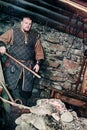 A blacksmith in a medieval forge, Historical reconstruction of the Viking village Svargas