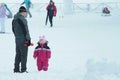 05.01.2020, Russia, Syktyvkar: Little girl with her father stand against snowy street