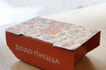 08-02-2020, Russia, Syktyvkar. Orange cardboard company box for Dodo snacks with a side inscription pizza and a corporate design