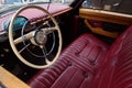 Red leather seat and dashboard of car GAZ-21 Volga. View from the drivers side