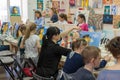 Russia, Tatarstan, April 21, 2019. Children`s drawing class. Easel, canvases, paints on the table. A group of children draw