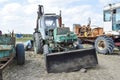 Tractor with a bucket for digging soil. Bulldozer and grader.