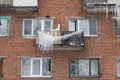 Russia. Terrible huge icicles formed on the balcony of a multi-storey building due to a poor roof storm system Royalty Free Stock Photo