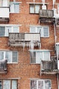 Russia. Terrible huge icicles formed on the balcony of a multi-storey building due to a poor roof storm system Royalty Free Stock Photo