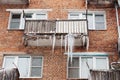 Russia. Terrible huge icicles formed on the balcony of a multi-storey building due to a poor roof storm system Royalty Free Stock Photo