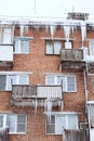 Russia. Terrible huge icicles formed on the balcony of a multi-storey building due to a poor roof storm system Royalty Free Stock Photo