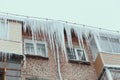 Russia. Terrible huge icicles formed on the balcony of a multi-storey building due to a poor roof storm system Royalty Free Stock Photo