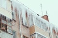 Russia. Terrible huge icicles formed on the balcony of a multi-storey building due to a poor roof storm system Royalty Free Stock Photo