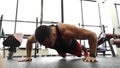 RUSSIA, TOGLIATTY - FEBRUARY 23, 2019: Young sports man performs pushups in the gym. The athlete is engaged in fitness