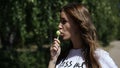 Russia, Togliatty - July 11, 2018: Beautiful girl sucks Lollipop in summer outdoors