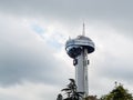 Russia, Tuapse 15.11.2020. High control tower with rounded top and transparent elevator shaft in side against cloudy sky