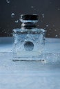 Eau de toilette, perfume Versace on a dark background and a blue substrate of water. With beautiful splashes of water.