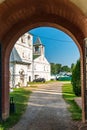 Russia, Uglich, July 2020. View of the road to the Orthodox monastery through the arch of the entrance.