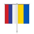 Russia and Ukraine flags hanging on metallic pole.