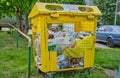 Russia, Vladimir, 02.06.2021, Yellow container for household garbage filled with garbage stands on the street.