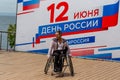 Russia, Vladivostok, 06/12/2018. Actor in wheelchair and usual actor perform the dance on stage. Annual celebration Russia Day on