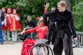 Russia, Vladivostok, 06/12/2018. Actor in wheelchair and usual actor perform the dance on stage. Annual celebration Russia Day on