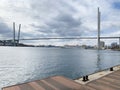 Russia, Vladivostok. Golden bridge - cable-stayed bridge across Golden horn Bay and fragment of  Tsarevich embankment in autumn in Royalty Free Stock Photo